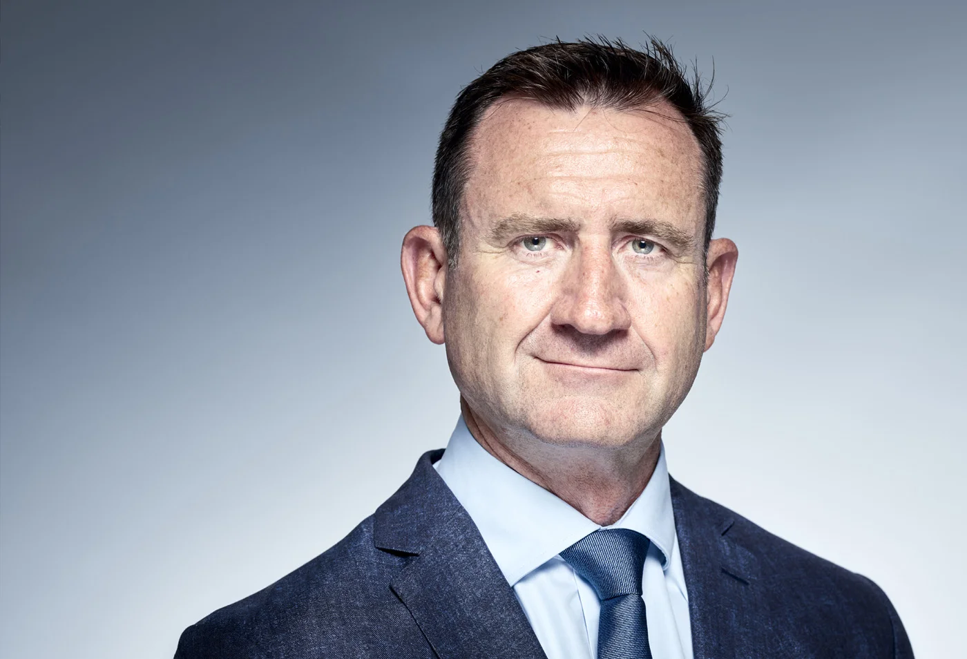 Businessporträt von Andrew Rennie im Anzug, zum Aufnahmezeitpunkt CEO Europe von Domino’s Pizza Enterprises.